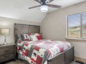 Bedroom with lofted ceiling and ceiling fan