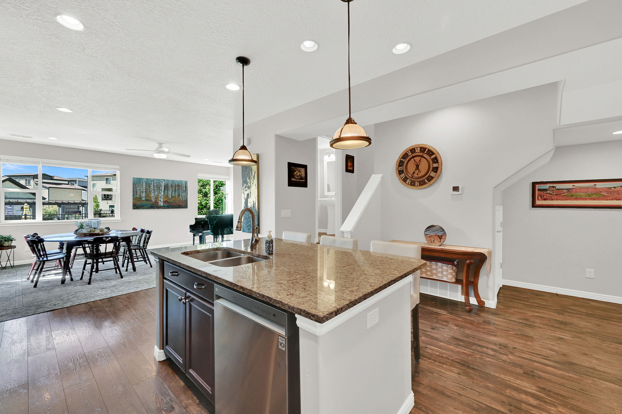 An additional view of the entire great room area, including the kitchen with stainless steel dishwasher