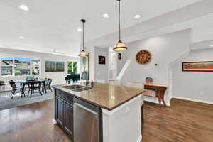 An additional view of the entire great room area, including the kitchen with stainless steel dishwasher
