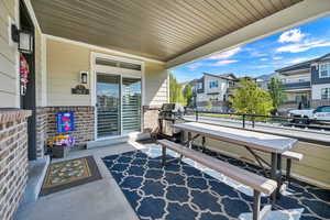 Front expansive entrance (on the left) porch/patio area showing the sliding door from the primary suite