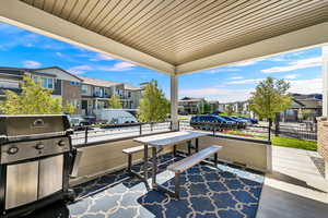 View of porch/patio terrace with area for grilling and a residential view