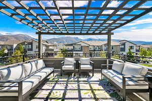 View of patio / terrace with outdoor lounge area, a mountain view, a residential view, and a pergola
