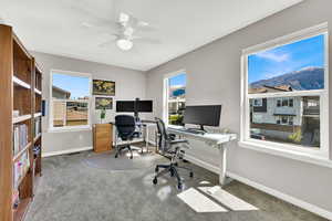 2nd Bedroom currently used as an office area with light carpet, a ceiling fan, and plenty of natural light