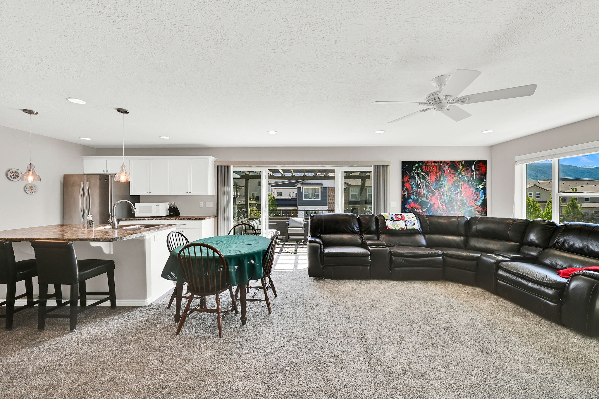 Living area featuring light carpet, healthy amount of natural light