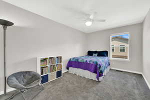 1st Bedroom with carpet flooring and a ceiling fan