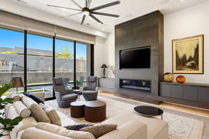 Living room featuring a ceiling fan and a fireplace