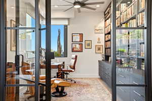 Office with light wood finished floors, a ceiling fan, and recessed lighting