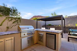 View of patio / terrace with a mountain view and an outdoor kitchen