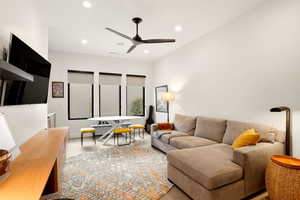 Living area featuring a ceiling fan, recessed lighting, and light wood-type flooring