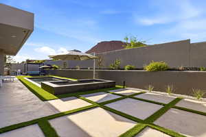 Fenced backyard with a patio area