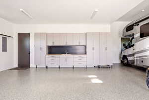 Garage with electric panel and a sink