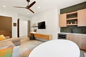 Bedroom with ceiling fan, wine cooler, wet bar, and recessed lighting