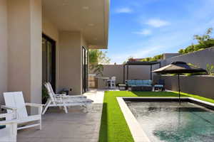 View of swimming pool featuring a fenced backyard, patio surround, outdoor lounge area, and area for grilling