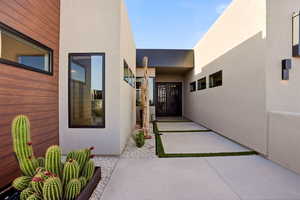 View of exterior entry featuring stucco siding