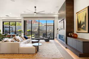 Living area featuring a ceiling fan, plenty of natural light, and recessed lighting