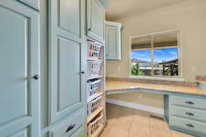Kitchen featuring light stone counters and light tile patterned floors