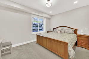 Bedroom with light carpet and recessed lighting
