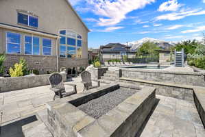 View of patio / terrace with a mountain view, a pool, and an outdoor fire pit