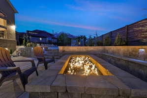Patio terrace at dusk with a mountain view and a fire pit