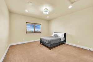 Bedroom with light carpet and recessed lighting