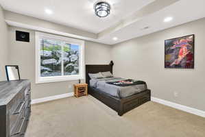 Bedroom featuring light colored carpet and recessed lighting