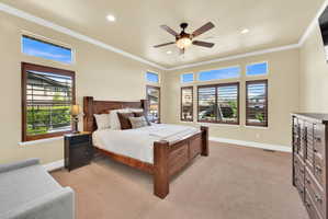 Bedroom with light carpet, a ceiling fan, ornamental molding, and recessed lighting