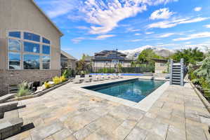 View of pool featuring patio surround and a mountain view