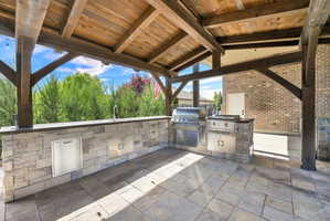 View of patio with exterior kitchen and a sink