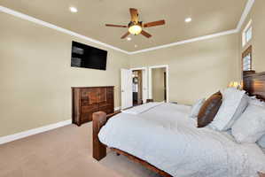 Bedroom featuring light carpet, ornamental molding, a ceiling fan, and recessed lighting