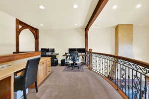 Office with light carpet, beamed ceiling, and recessed lighting