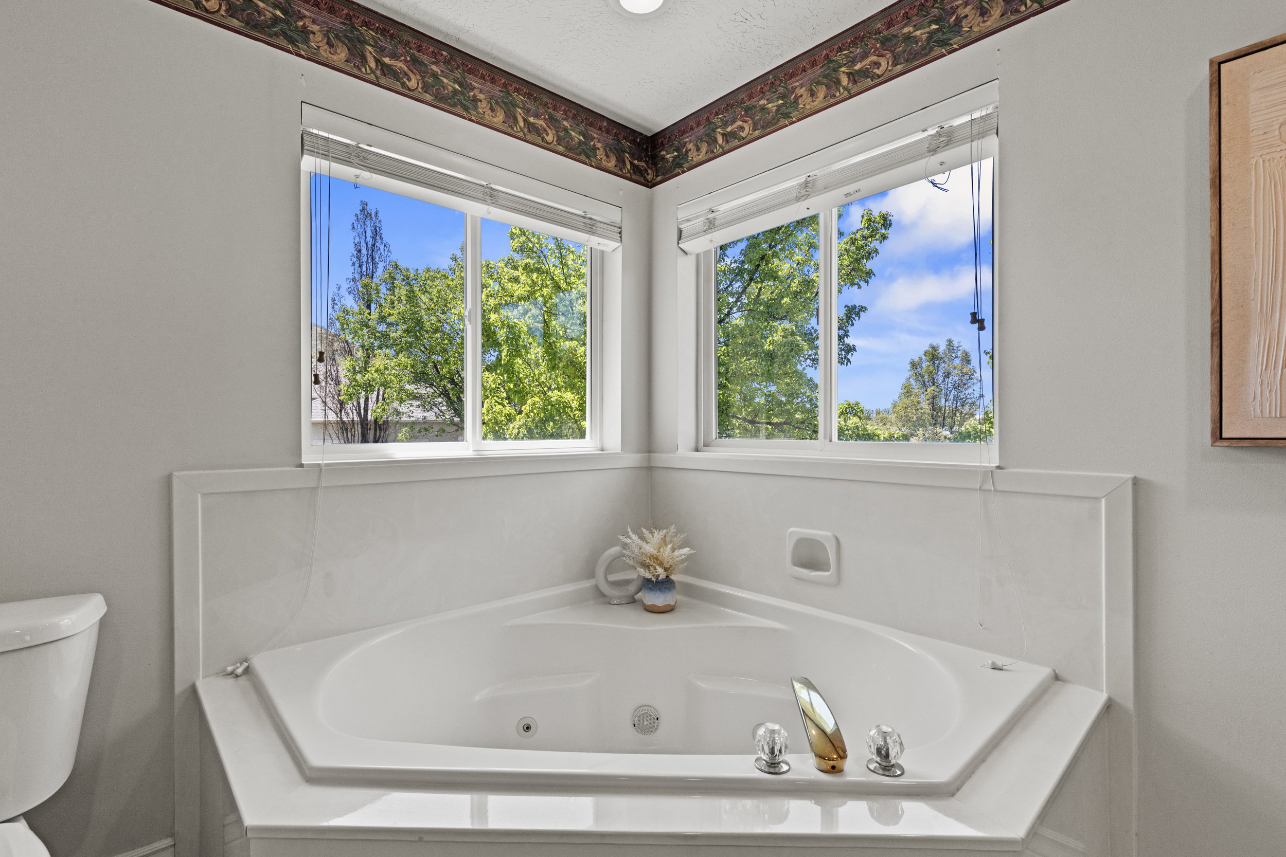 Full bath with a whirlpool tub and plenty of natural light