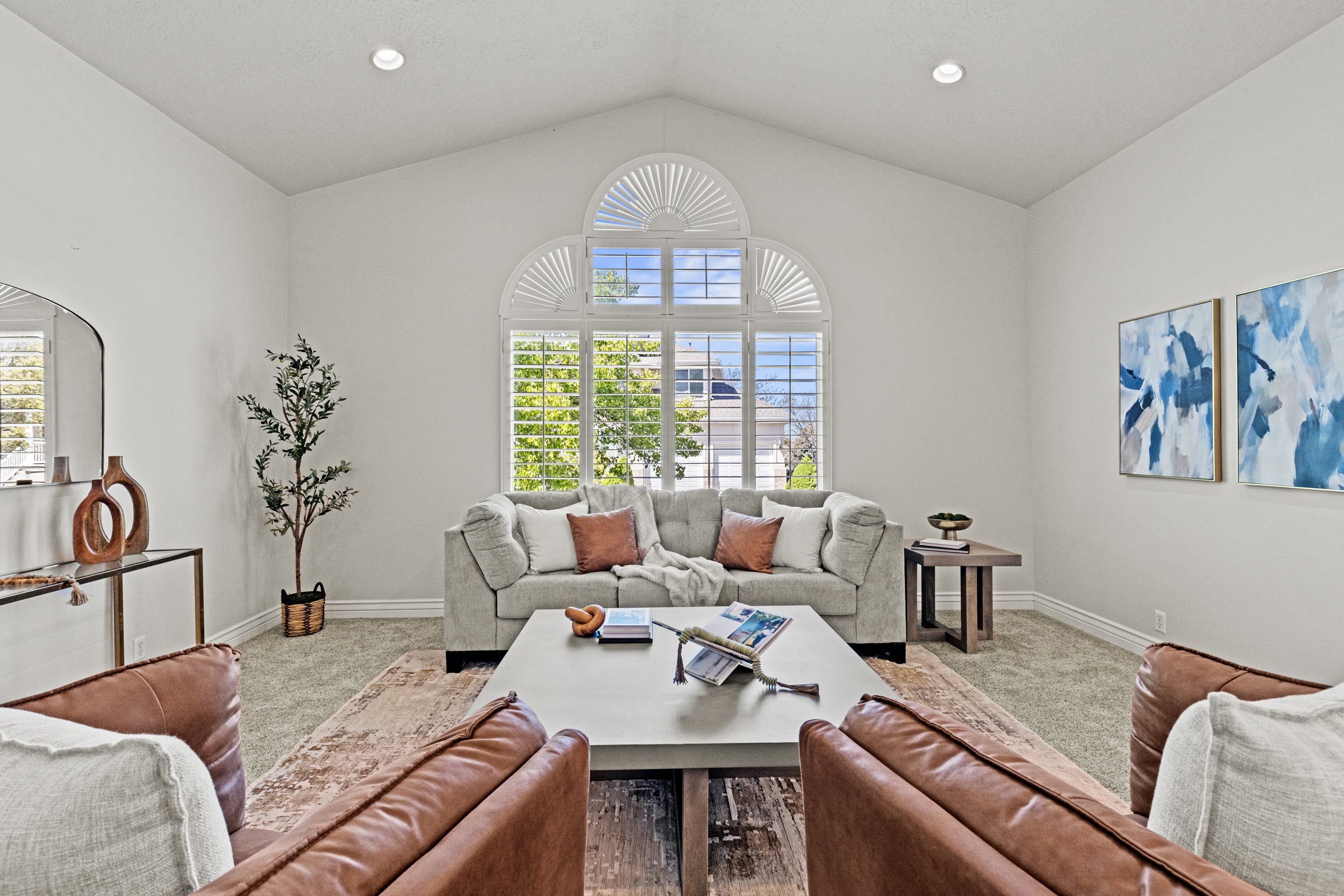 Carpeted living room with healthy amount of natural light and recessed lighting