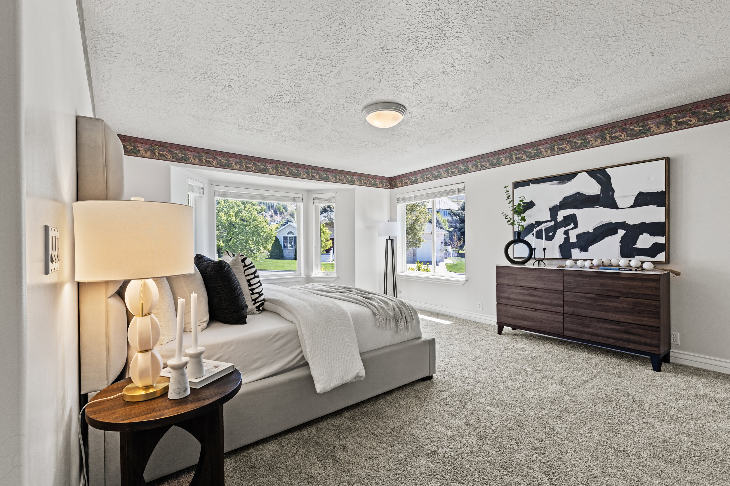 Bedroom with a textured ceiling and light colored carpet