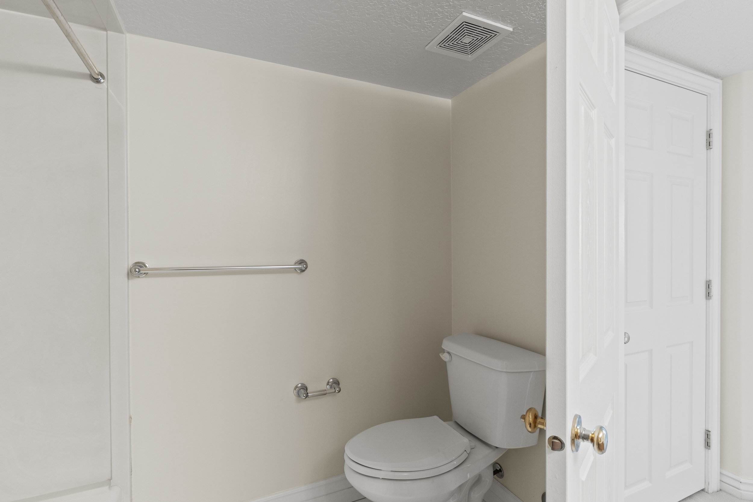 Bathroom featuring toilet and a textured ceiling