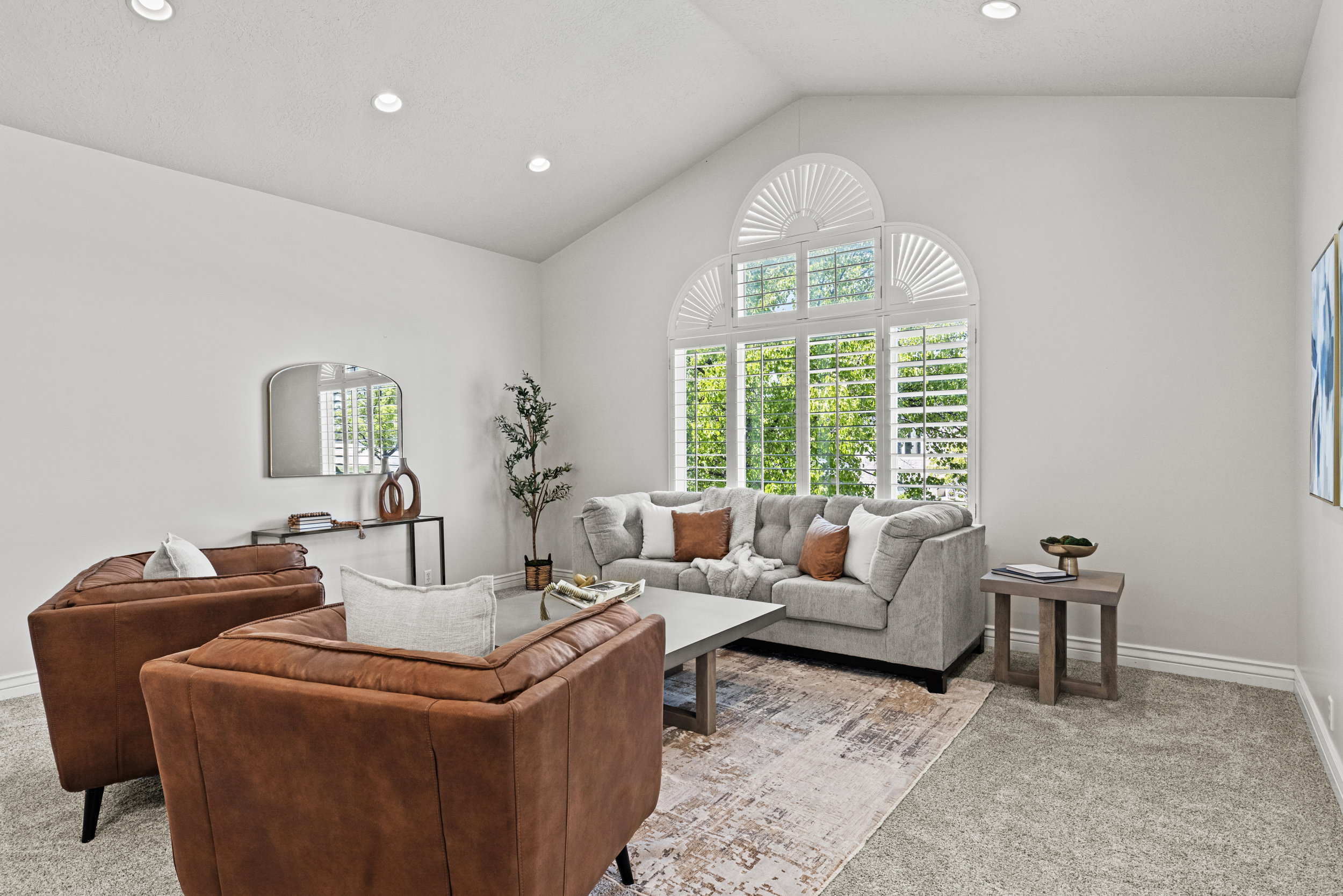 Living area featuring light carpet and recessed lighting