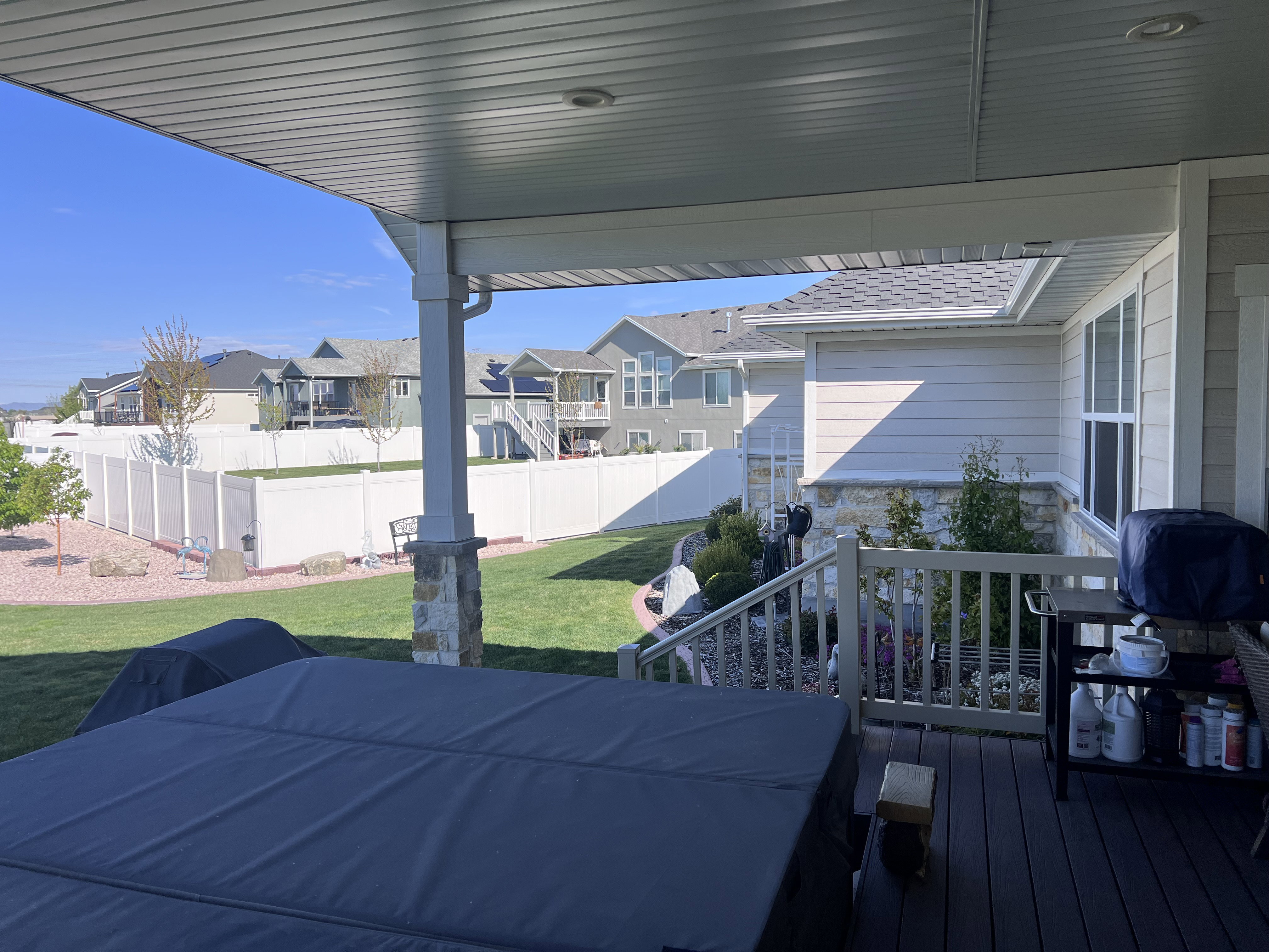 Wooden terrace featuring a fenced backyard and a residential view