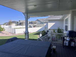 Wooden terrace featuring a fenced backyard and a residential view