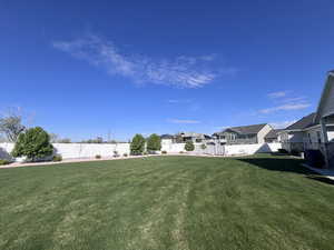 Fenced backyard featuring a residential view