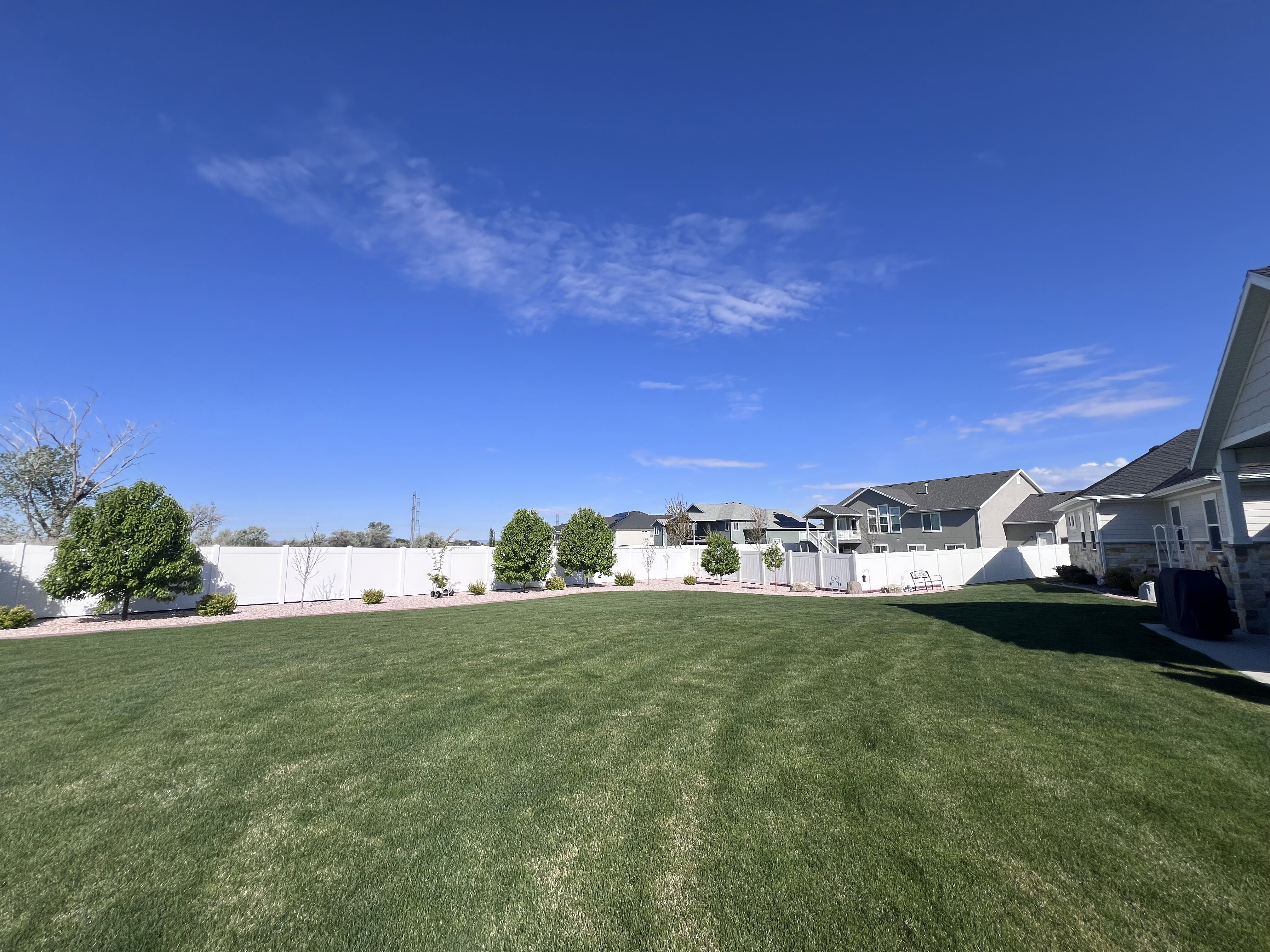 Fenced backyard featuring a residential view