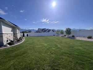 Fenced backyard with a mountain view