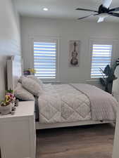 Bedroom with dark wood-style floors, ceiling fan, and recessed lighting