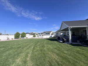 Fenced backyard with a residential view and a patio