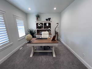Office featuring dark carpet and recessed lighting