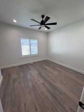 Empty room featuring dark wood-type flooring, recessed lighting, and ceiling fan
