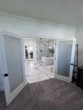Hallway featuring french doors, crown molding, and marble finish floors