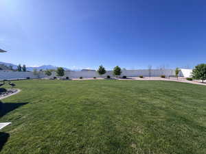 Fenced backyard featuring a mountain view