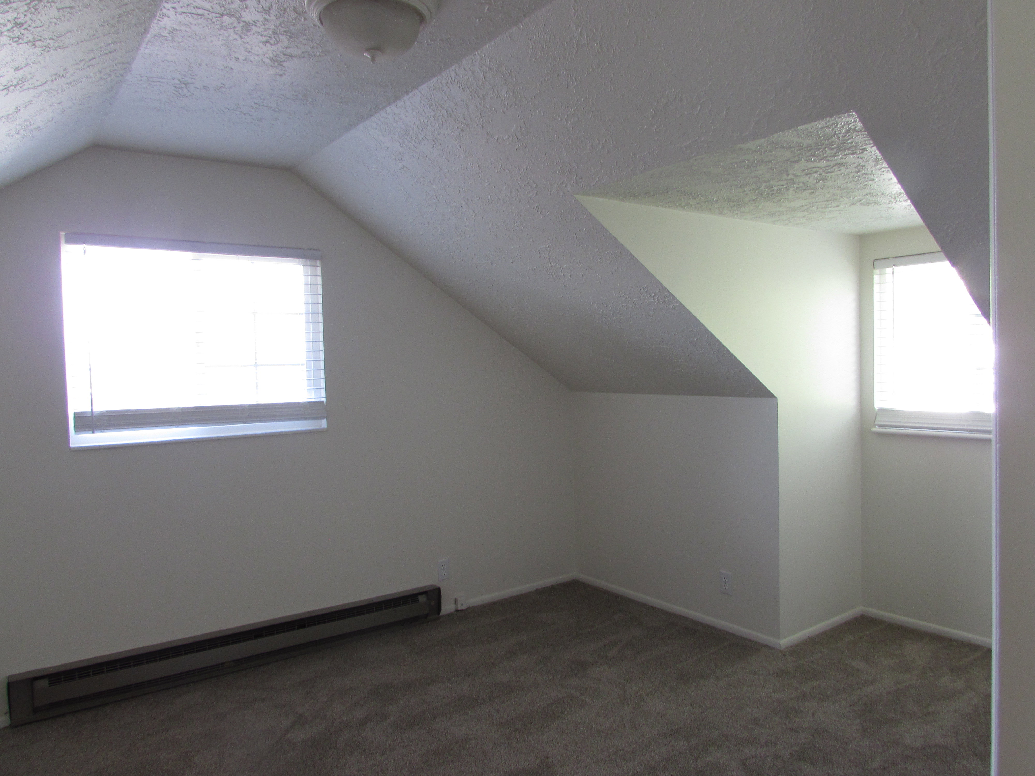 Bedroom with baseboard heating and  carpet
