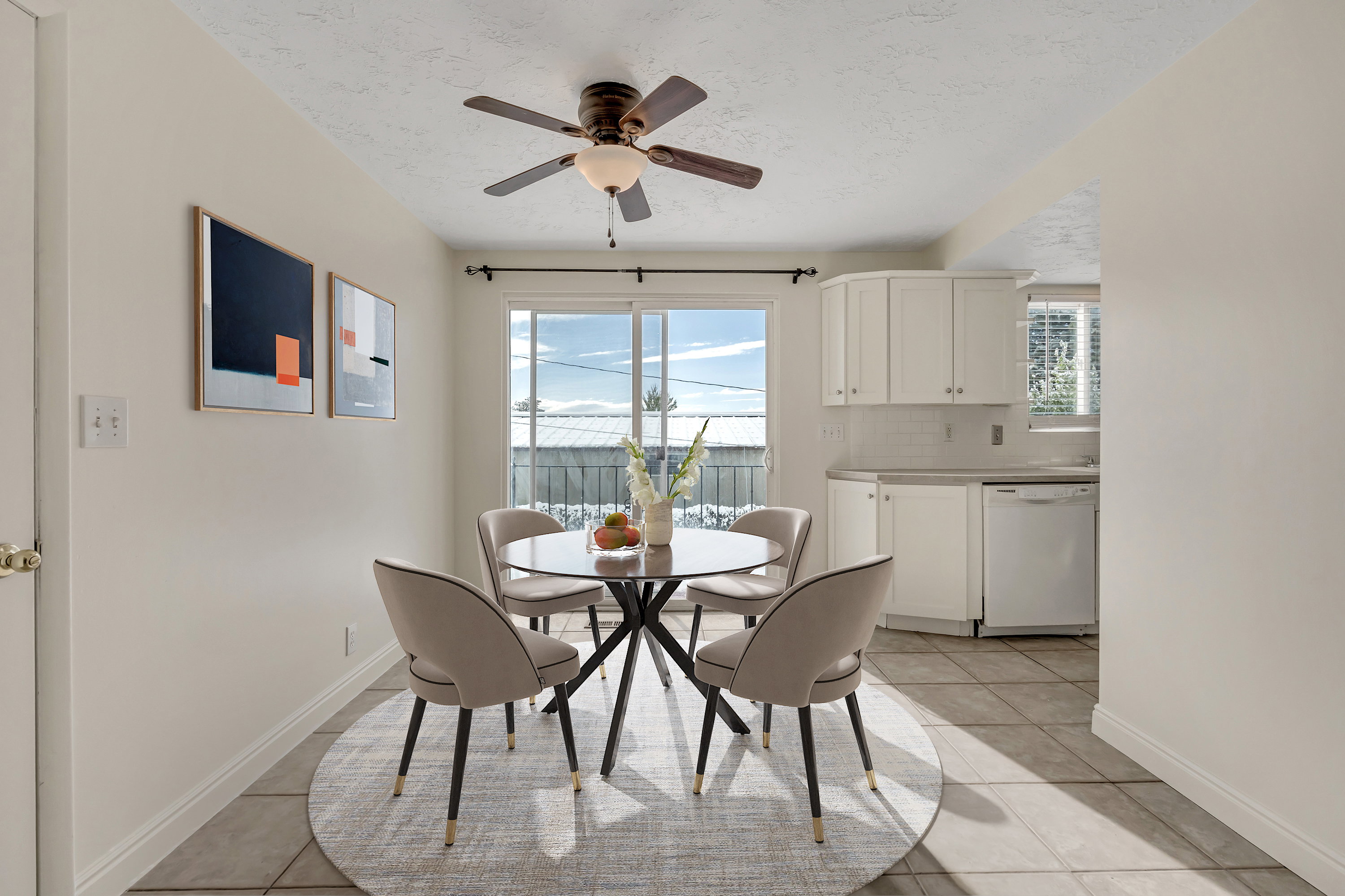 Dining area featuring light tile patterned floors, a ceiling fan, plenty of natural light, and a textured ceiling (virtually staged)