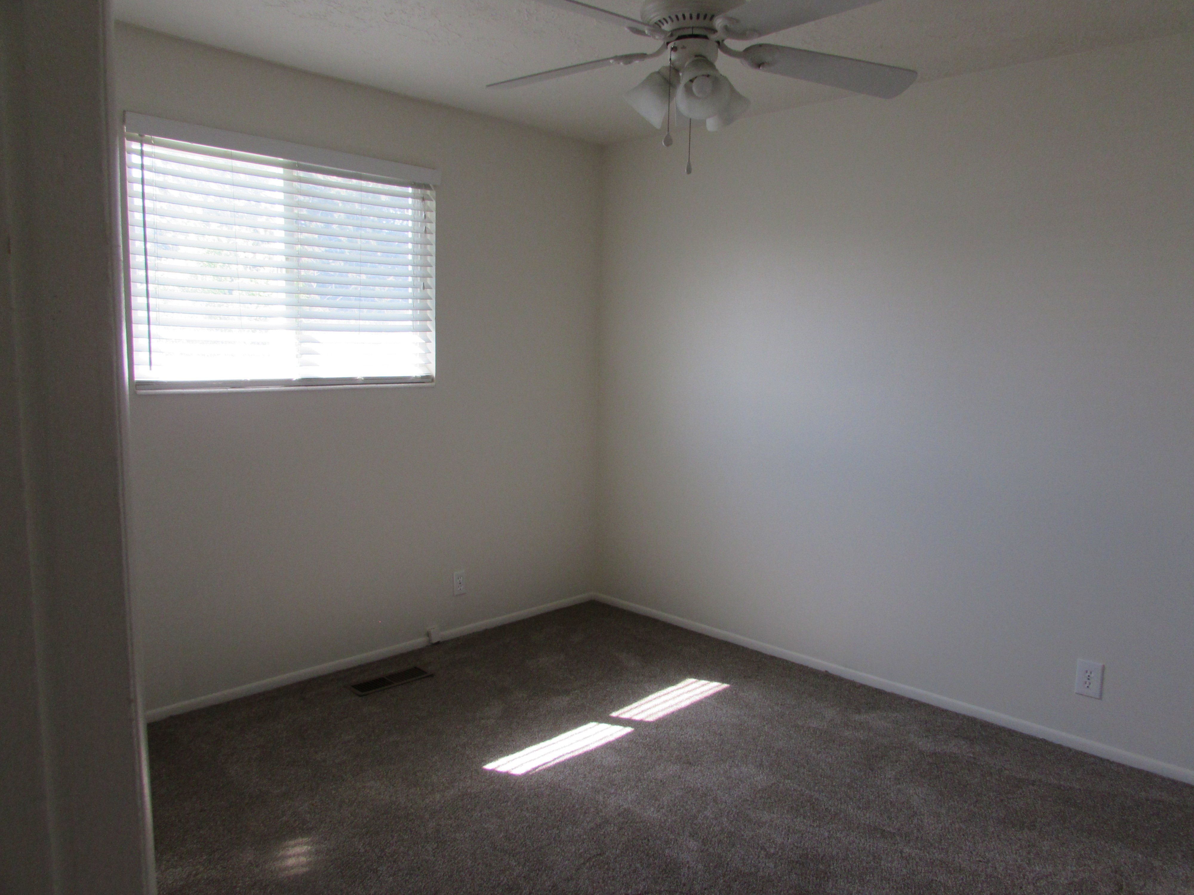 Bedroom featuring a ceiling fan and new carpet