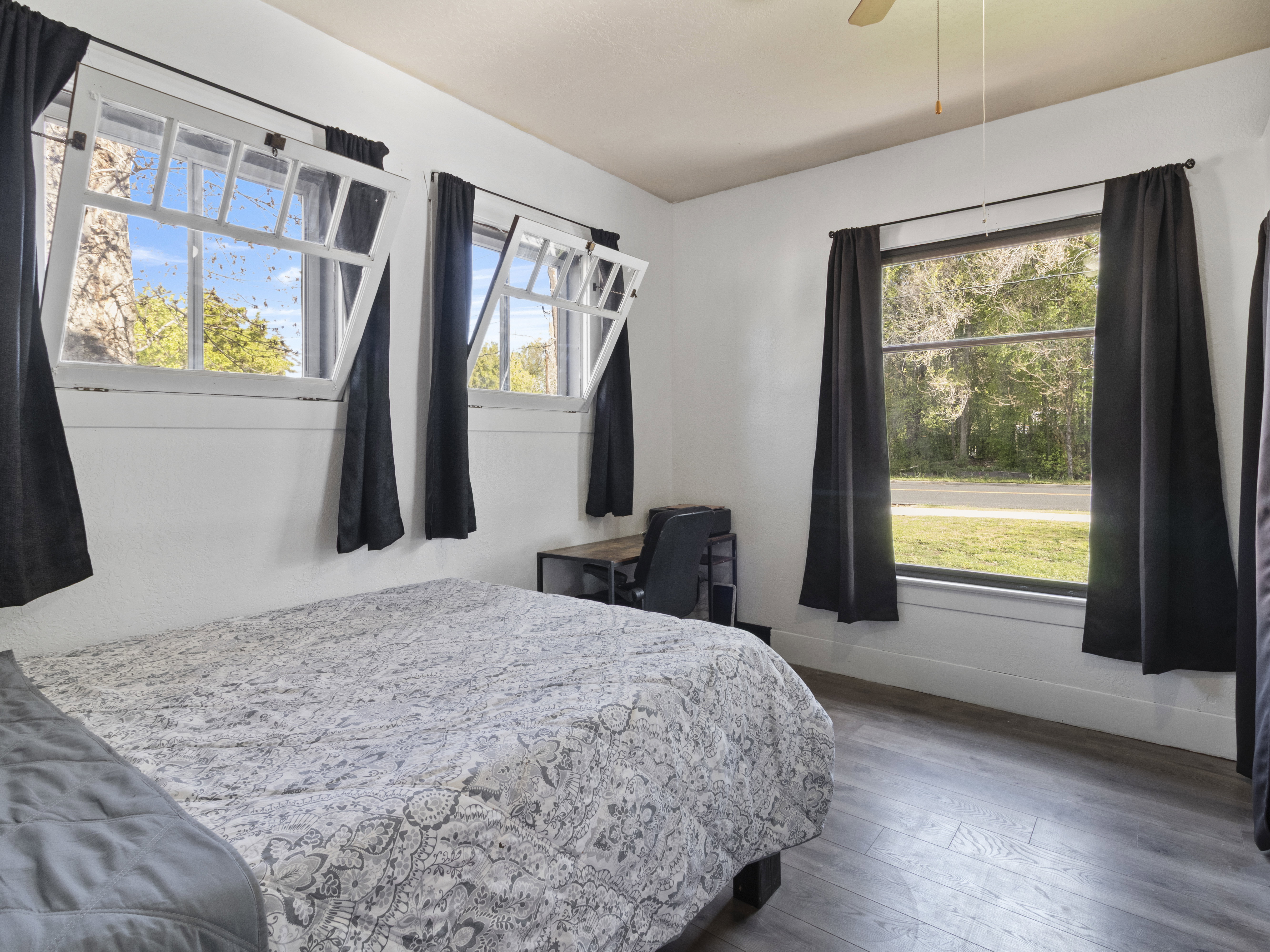 Bedroom featuring dark wood-style flooring and baseboards